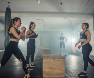 Women practicing martial arts techniques in a supportive, all-female training environment