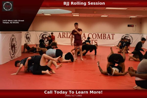 Two beginners sparring with full protective gear under coach supervision at Arizona Combat Sports in Tempe, Arizona.