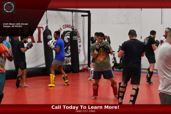 Students training martial arts indoors at Arizona Combat Sports during Arizona summer heat