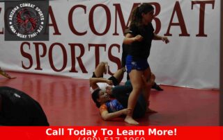 Women practicing BJJ leverage technique on the mat at Arizona Combat Sports in Tempe AZ