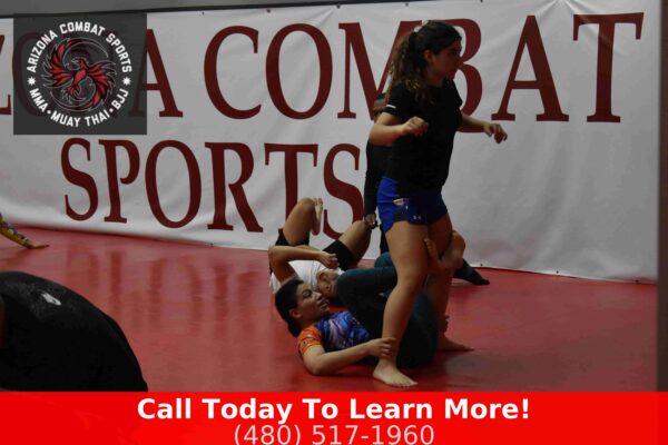 Women practicing BJJ leverage technique on the mat at Arizona Combat Sports in Tempe AZ
